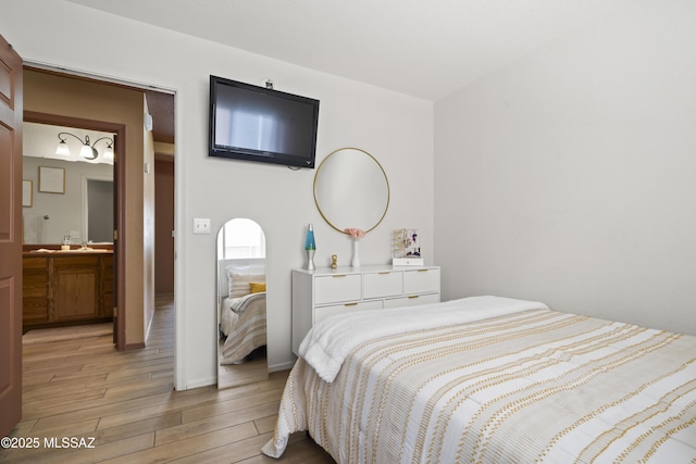 bedroom with baseboards and light wood finished floors