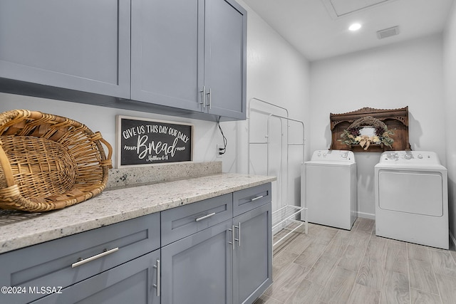 washroom featuring visible vents, recessed lighting, cabinet space, light wood-style floors, and washer and dryer