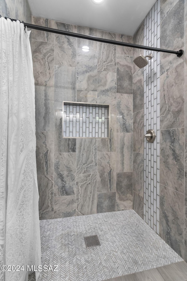 bathroom with tiled shower