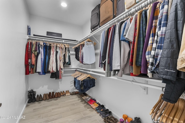 spacious closet featuring wood finish floors