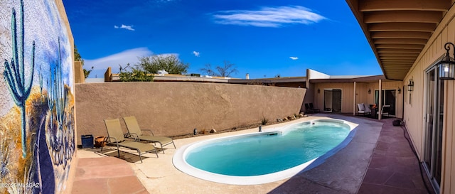 view of pool with a patio area, a fenced in pool, and fence