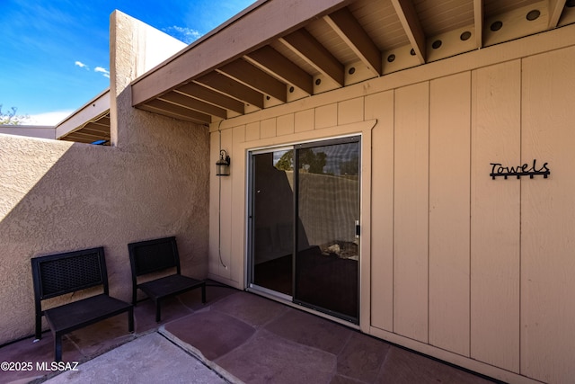 exterior space with a patio area and stucco siding