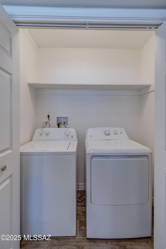 washroom with laundry area, washer and dryer, and dark wood-style flooring