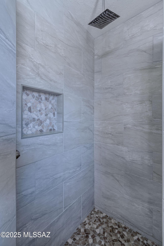 full bath featuring tiled shower