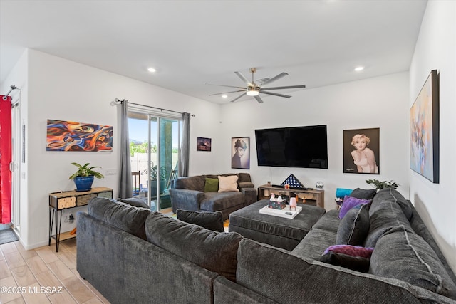 living area with baseboards, recessed lighting, light wood-type flooring, and ceiling fan