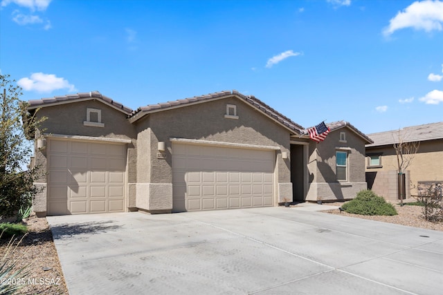 ranch-style house with a tile roof, stucco siding, driveway, and an attached garage