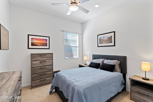 bedroom with ceiling fan, baseboards, and light carpet