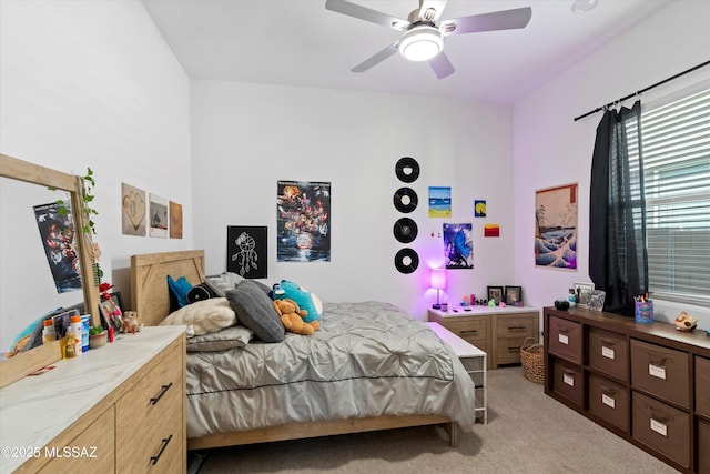 bedroom with light carpet and a ceiling fan