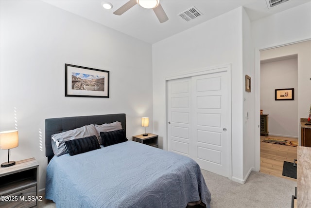 bedroom featuring visible vents, a closet, carpet floors, baseboards, and ceiling fan