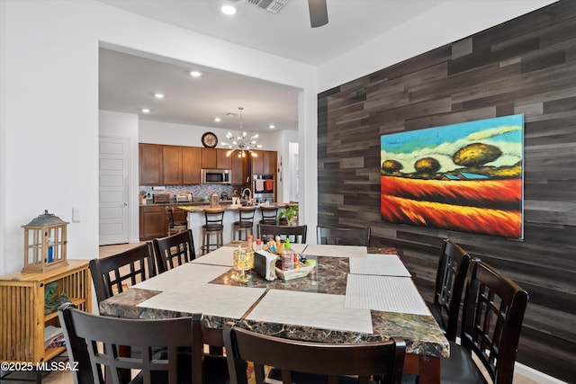 dining area featuring recessed lighting, ceiling fan with notable chandelier, and visible vents