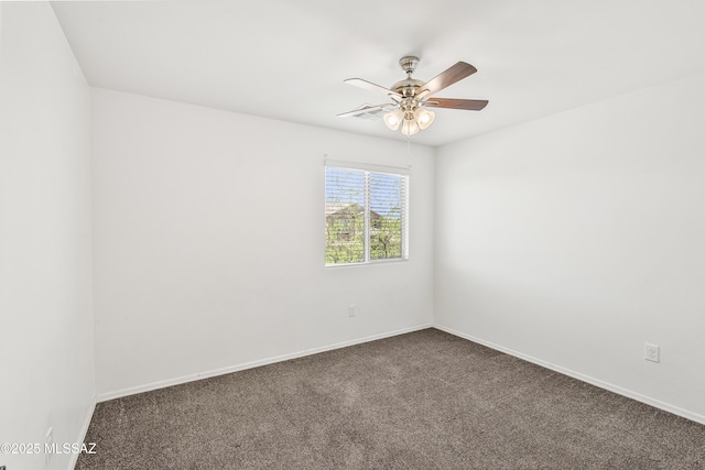 carpeted spare room featuring baseboards and ceiling fan