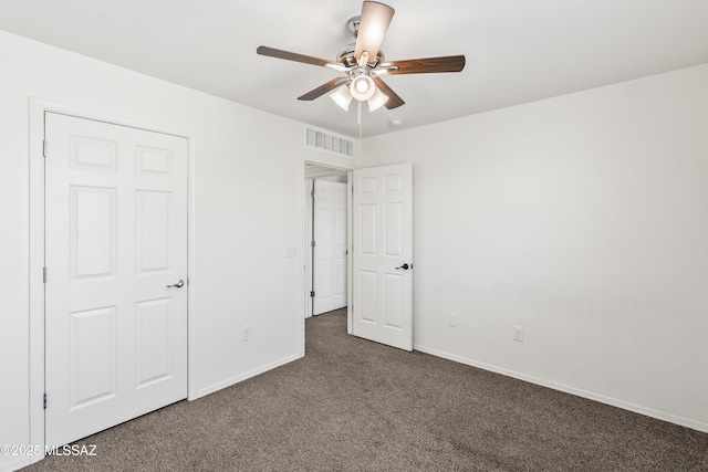 unfurnished bedroom with ceiling fan, baseboards, visible vents, and carpet