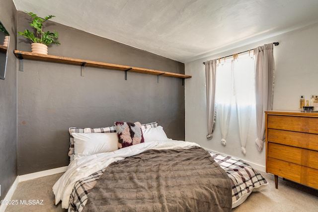 bedroom featuring baseboards and carpet