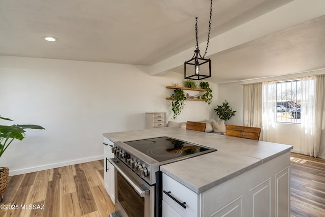 kitchen with stainless steel electric range oven, white cabinets, and light wood finished floors