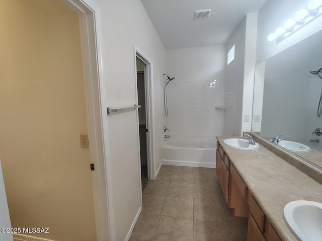 bathroom with double vanity, visible vents, tile patterned flooring, and a sink