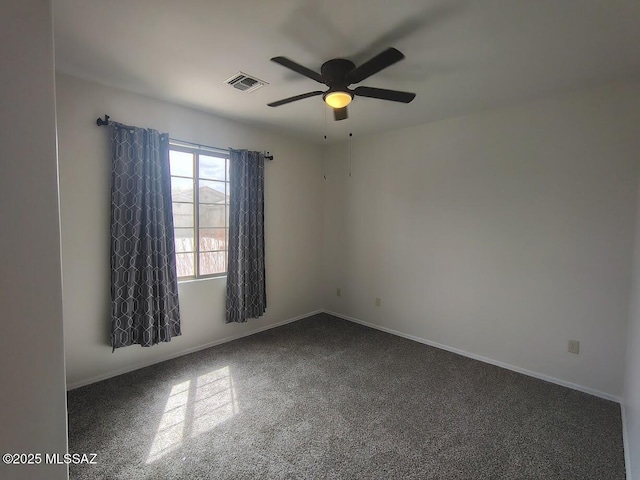 unfurnished room featuring a ceiling fan, visible vents, and baseboards