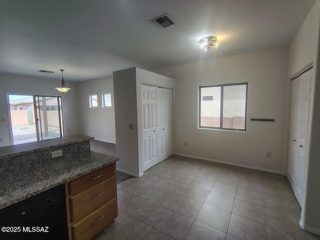 kitchen with light tile patterned floors, visible vents, baseboards, and dishwasher