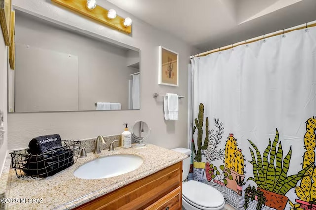 bathroom featuring vanity, a shower with curtain, and toilet