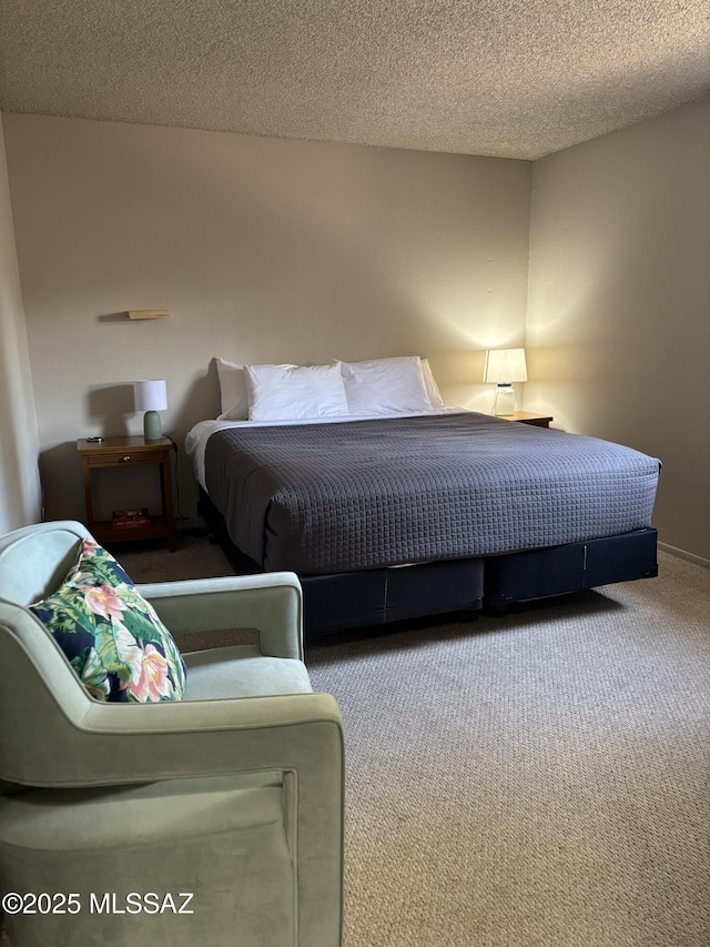 bedroom featuring a textured ceiling and carpet