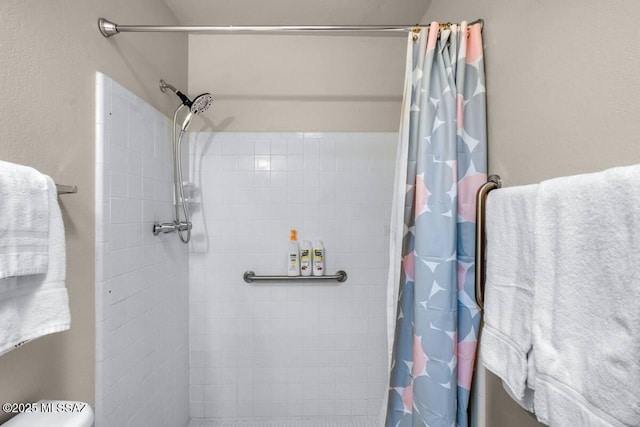 full bathroom with tiled shower