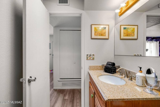 bathroom with vanity, wood finished floors, and visible vents