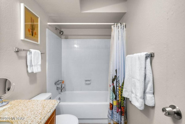 bathroom featuring vanity, shower / tub combo with curtain, and toilet