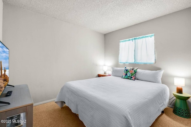carpeted bedroom with baseboards and a textured ceiling