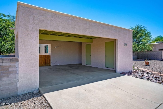 exterior space featuring fence and stucco siding