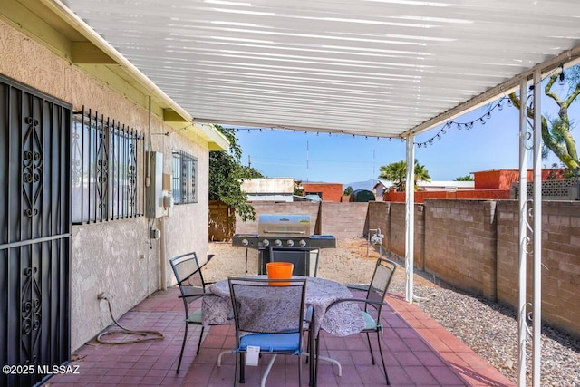 view of patio / terrace featuring outdoor dining area, a fenced backyard, and a grill