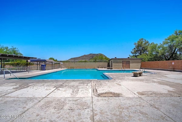community pool featuring a patio and fence
