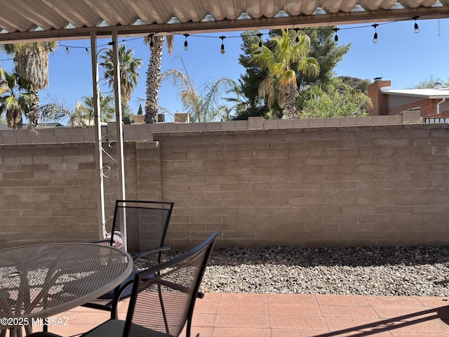 view of patio / terrace featuring fence and outdoor dining space