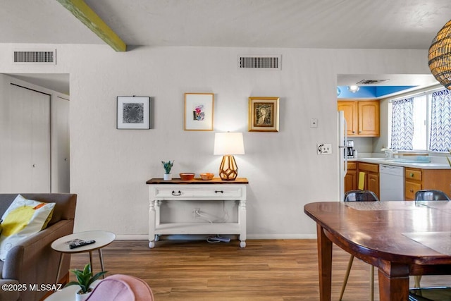 dining space with visible vents and light wood finished floors