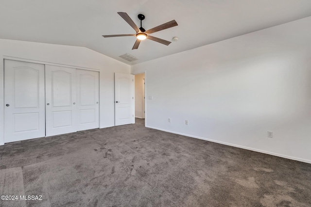 unfurnished bedroom with visible vents, baseboards, carpet, lofted ceiling, and a closet