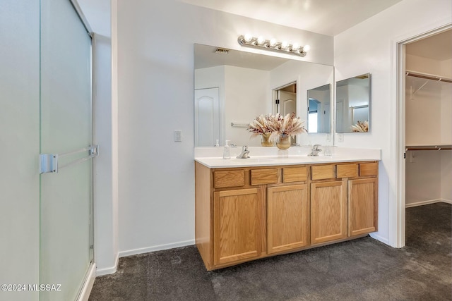 bathroom with a spacious closet, visible vents, double vanity, carpet flooring, and a sink