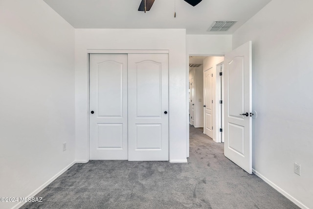 unfurnished bedroom with visible vents, baseboards, carpet, and a closet