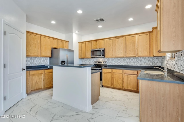 kitchen with visible vents, a sink, appliances with stainless steel finishes, dark countertops, and marble finish floor