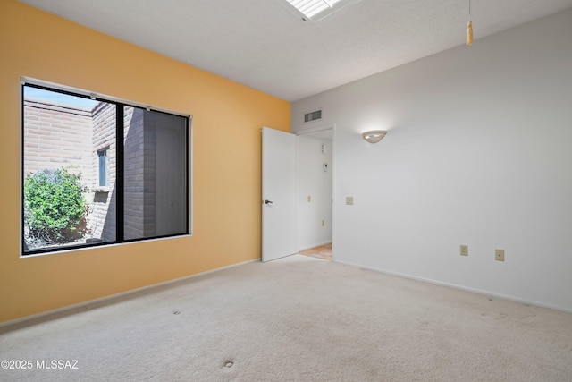 carpeted empty room with baseboards and visible vents