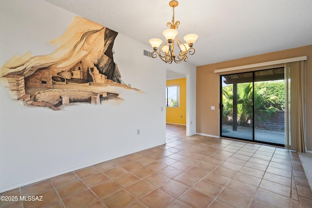 spare room with plenty of natural light, visible vents, tile patterned flooring, and a chandelier