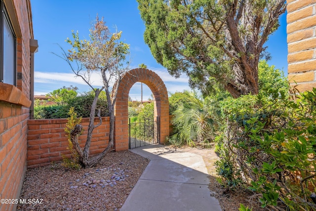 view of yard with fence and a gate