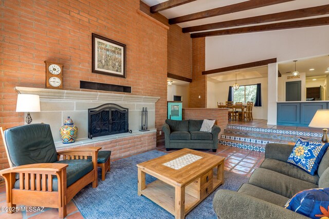 living room with tile patterned floors, beamed ceiling, high vaulted ceiling, and a brick fireplace