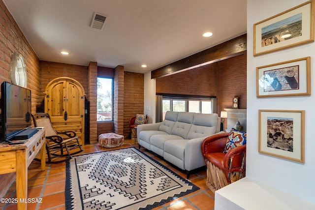 living room featuring rustic walls, visible vents, tile patterned flooring, and recessed lighting