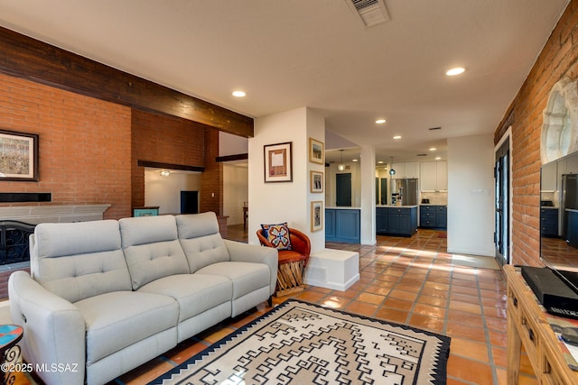 living room with light tile patterned floors, visible vents, brick wall, beam ceiling, and recessed lighting