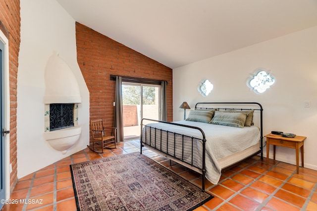 tiled bedroom featuring access to exterior and vaulted ceiling