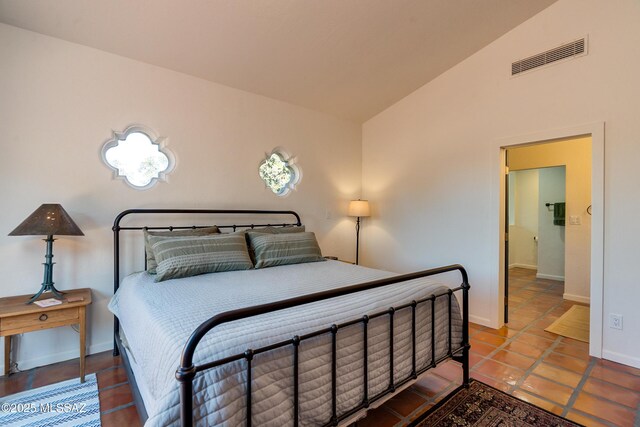 bedroom featuring visible vents, baseboards, and vaulted ceiling