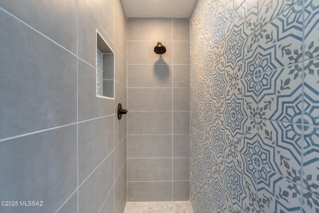 full bath with a tile shower