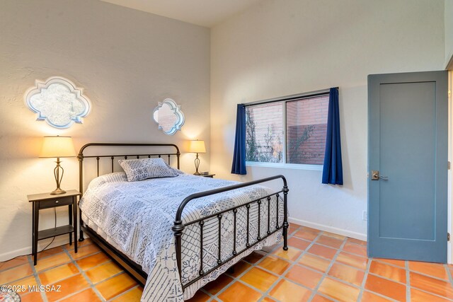 bedroom with tile patterned flooring and baseboards