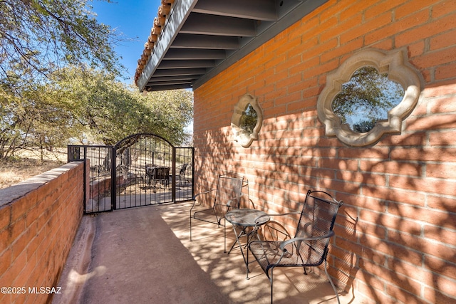 view of patio with a gate