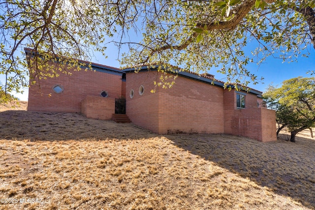 view of property exterior with brick siding