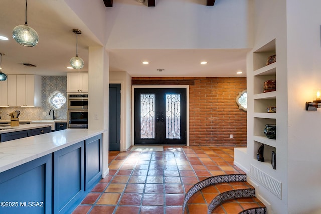 entryway featuring recessed lighting, visible vents, and french doors