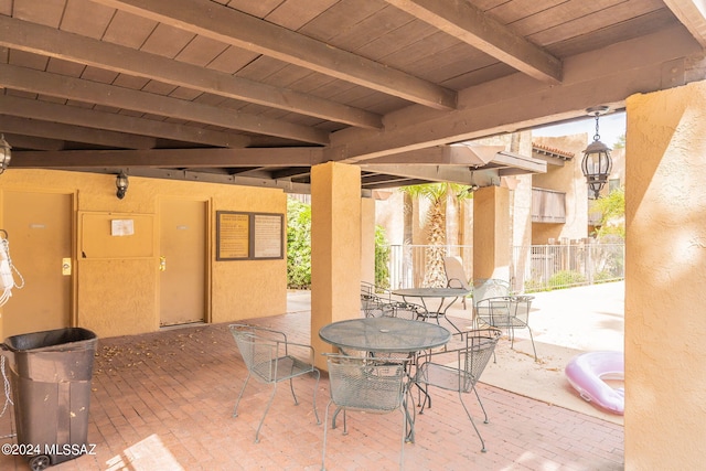 view of patio featuring outdoor dining space and fence